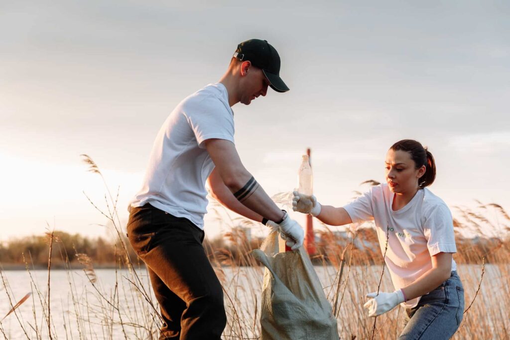 People collecting plastic waste at river